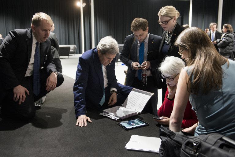 US Secretary of State John Kerry (2L) and US Under Secretary for Political Affairs Wendy Sherman (2R) listen on April 2, 2015 in Lausanne, as US President Barack Obama addresses the US people on the status of Iran nuclear program talks