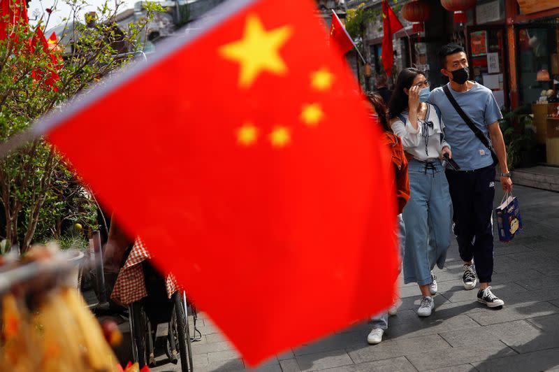 People walk in the tourist area surrounding Houhai Lake during Chinese National Day holidays in Beijing