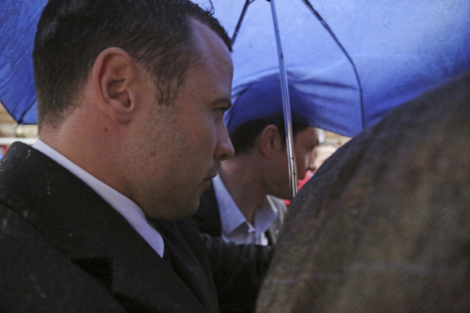 Oscar Pistorius arrives at the high court after the first day of his trial in Pretoria, South Africa, Tuesday, March 4, 2014. Pistorius is charged with murder with premeditation in the shooting death of girlfriend Reeva Steenkamp in the pre-dawn hours of Valentine's Day 2013. (AP Photo/Schalk van Zuydam)