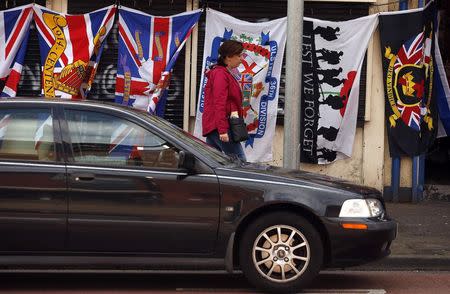 Various flags are displayed for sale outside a shop on Loyalist Shankill road in West Belfast August 18, 2014. REUTERS/Cathal McNaughton