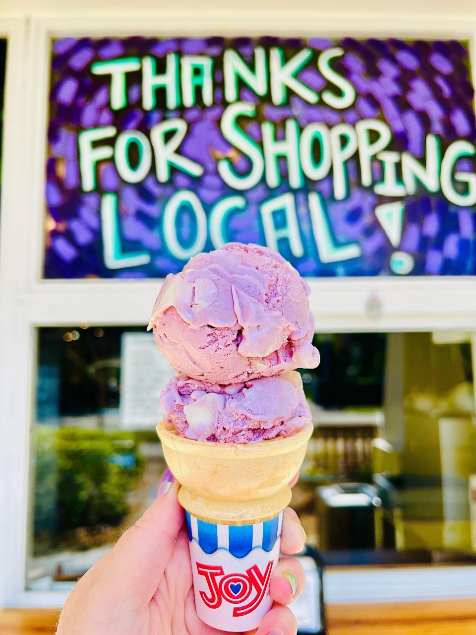 Neighbors Ice Cream Parlor's Purple Cow ice cream, which is black raspberry flavored with pieces of white chocolate hard shell.