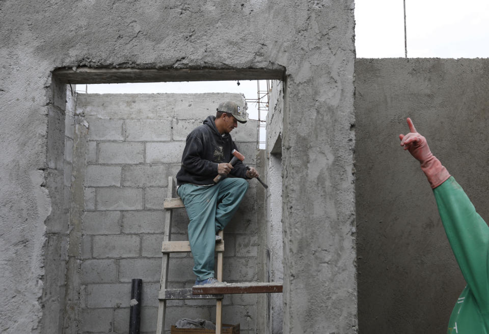 In this Dec. 5, 2018 photo, Honduran migrant Reyes Franco, 39, works as a day laborer at a construction site in Tijuana, Mexico. Mexican authorities have encouraged all of the migrants to regularize their status in Mexico and seek work. (AP Photo/Rebecca Blackwell)