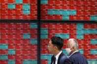People look at an electronic stock board showing Japan's Nikkei 225 index at a securities firm Thursday, May 9, 2024, in Tokyo. (AP Photo/Eugene Hoshiko)