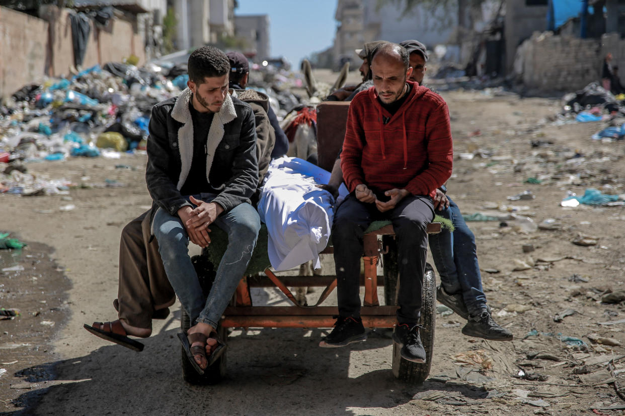 The body of a person killed in Gaza City is carried on a donkey pulled cart.