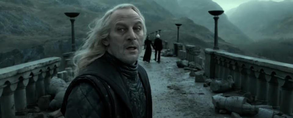 Lucius Malfoy looks back as his family leaves a battle