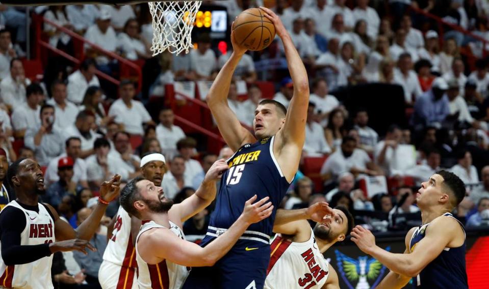 Miami Heat forward Kevin Love (42) and Miami Heat guard Max Strus (31) defend against Denver Nuggets center Nikola Jokic (15) in the first half of Game 4 of the NBA Finals at the Kaseya Center in downtown Miami, Fla. on Friday, June 9, 2023.