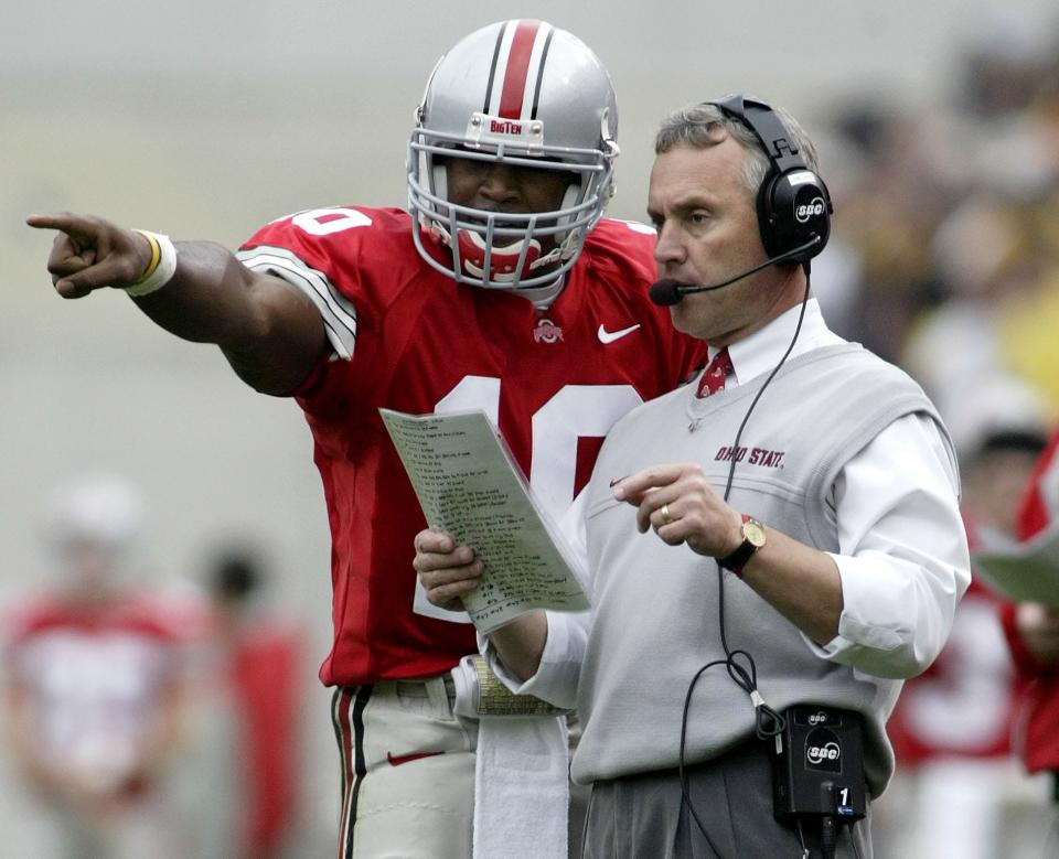 Ohio State's Troy Smith, left, consults with coach Jim Tressel during a game against Michigan in 2004.