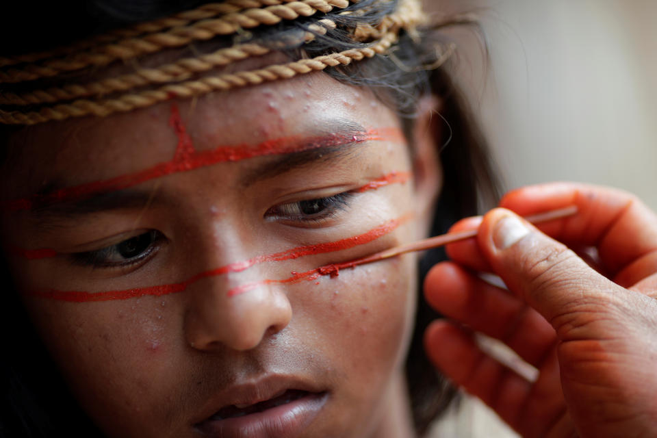 An Indigenous man from the Mura tribe paints his face in Itaparana village near Humaita, Amazonas State.