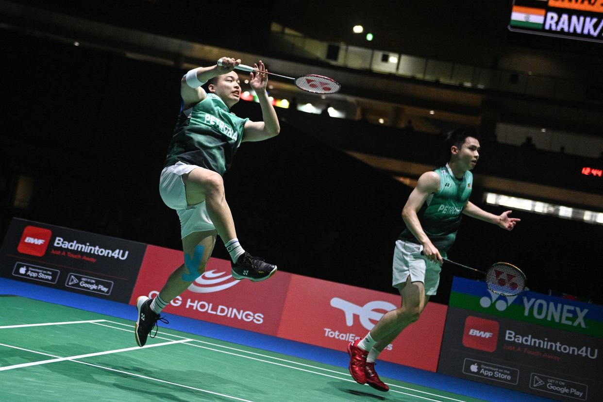 Malaysia men's doubles duo Aaron Chia (left) and Soh Wooi Yik return a shot during their semi-final match at the 2022 Badminton World Championships in Tokyo.