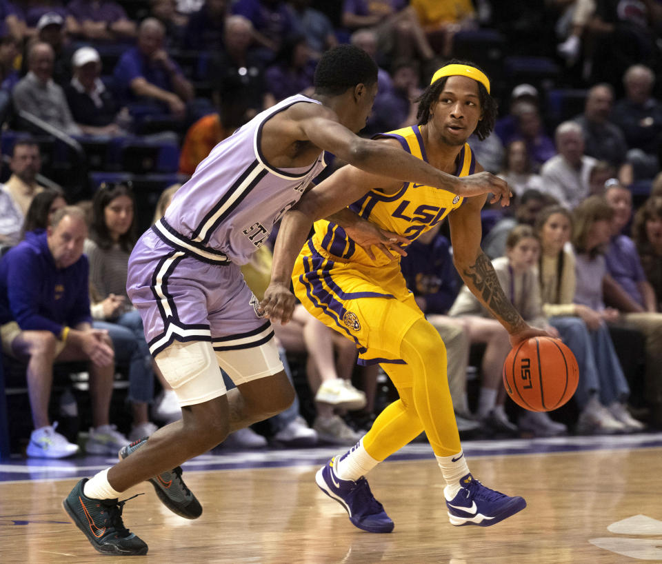 LSU guard Mike Williams III (2) drives the ball around Kansas State guard Cam Carter (5) during an NCAA college basketball game, Saturday, Dec. 9, 2023, at the LSU PMAC in Baton Rouge, La. (Hilary Scheinuk/The Advocate via AP)