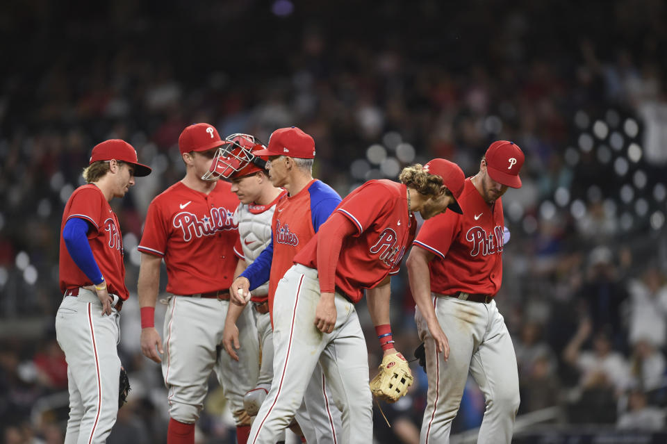 Philadelphia Phillies manager Joe Girardi removes starting pitcher Aaron Nola, right, for relief pitcher Corey Knebel during the ninth inning of the team's baseball game against the Atlanta Braves on Thursday, May 26, 2022, in Atlanta. (AP Photo/Hakim Wright Sr.)