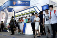 People walk past the Cambridge University Press (CUP) stall at the Beijing International Book Fair in Beijing, China, August 23, 2017. REUTERS/Thomas Peter