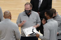 Milwaukee Bucks head coach Mike Budenholzer, center, talks strategy with assistants during a timeout in the second half of an NBA basketball game against the Minnesota Timberwolves, Wednesday, April 14, 2021, in Minneapolis. The Bucks won 130-105. (AP Photo/Jim Mone)