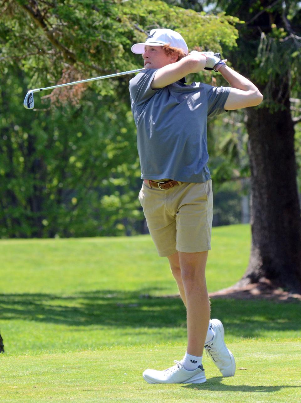 Charlevoix's Hudson Vollmer watches a tee shot during Tuesday's round in Harbor Springs.