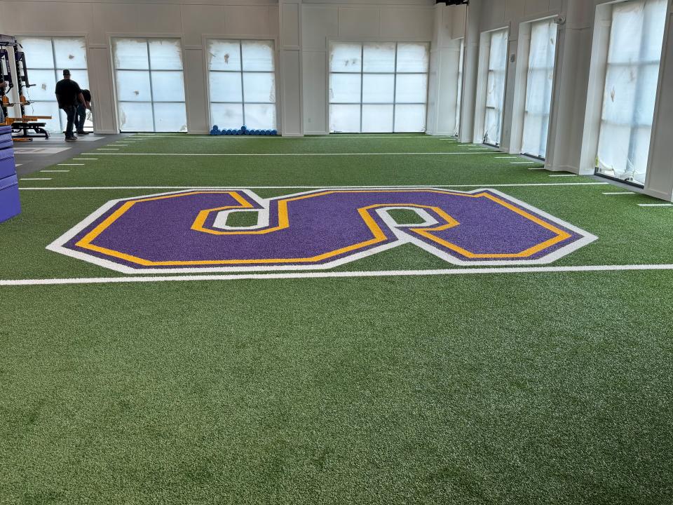 A 10-yard by 30-yard stretch of artificial turf is included inside the weight room at Smyrna High's new athletic facility.