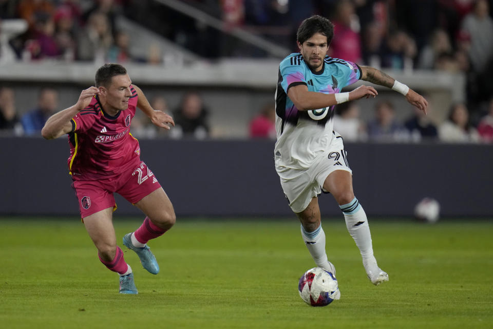 St. Louis City's Kyle Hiebert, left, and Minnesota United's Luis Amarilla (9) challenge for the ball during the first half of an MLS soccer match Saturday, April 1, 2023, in St. Louis. (AP Photo/Jeff Roberson)