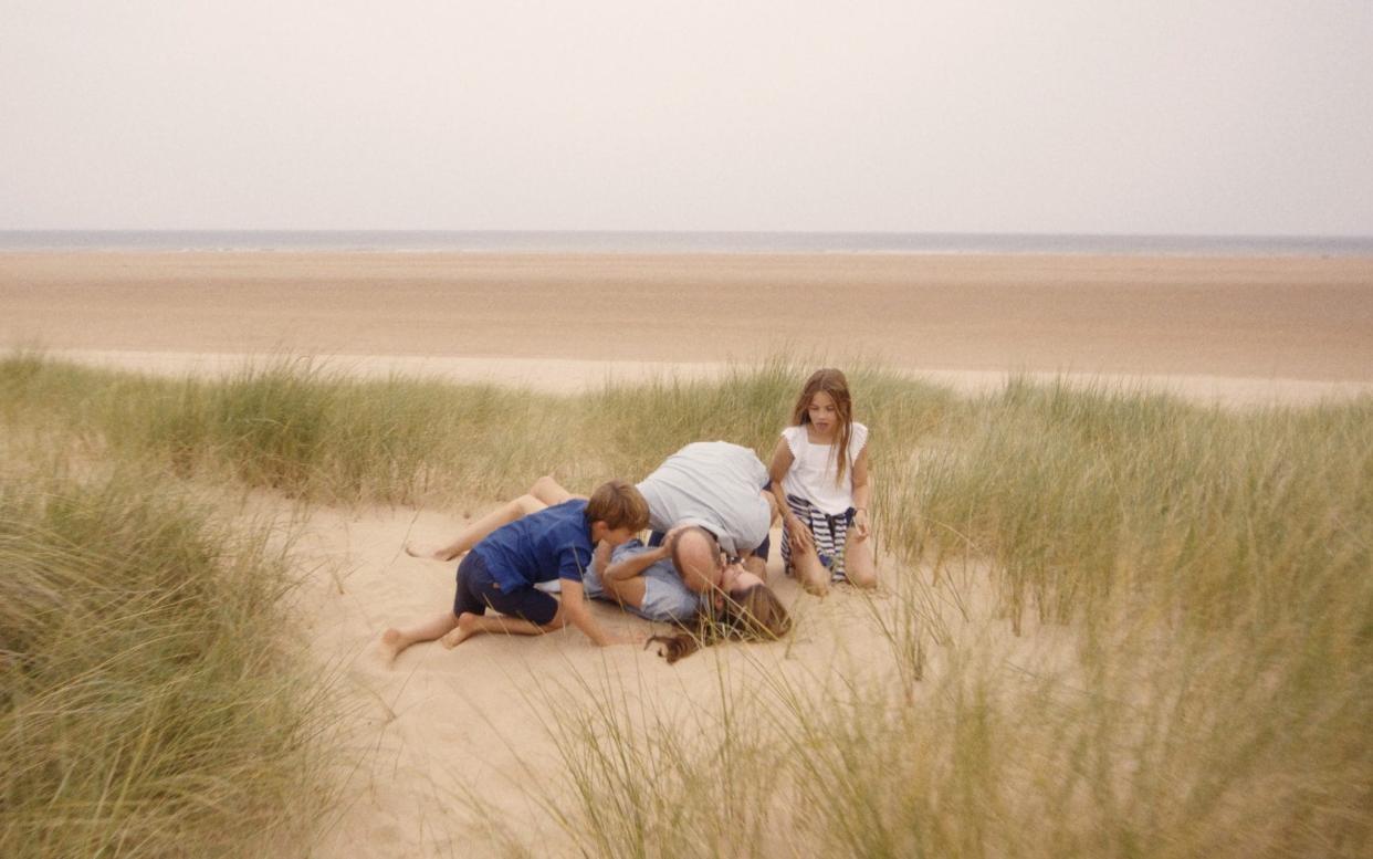 In one intimate shot, the family are seen lying on a Norfolk beach, embracing