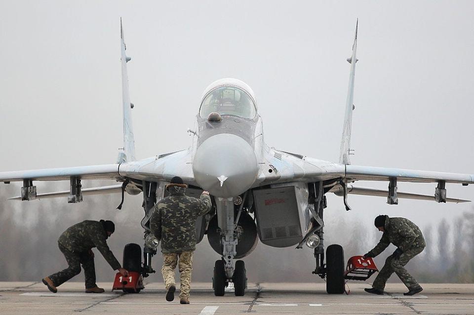 A ground staff directs Mig-29 fighter jet of Ukrainian Air Force after a flight a during a training session in a military airbase in Vasylkiv village, some 30km of Kyiv, Ukraine, Wednesday, November 23, 2016.