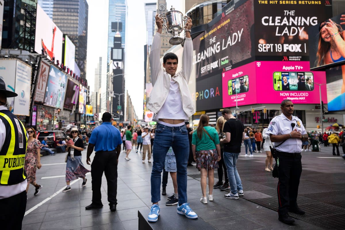 Carlos Alcaraz held up the US Open trophy in Times Square (Yuki Iwamura/AP) (AP)