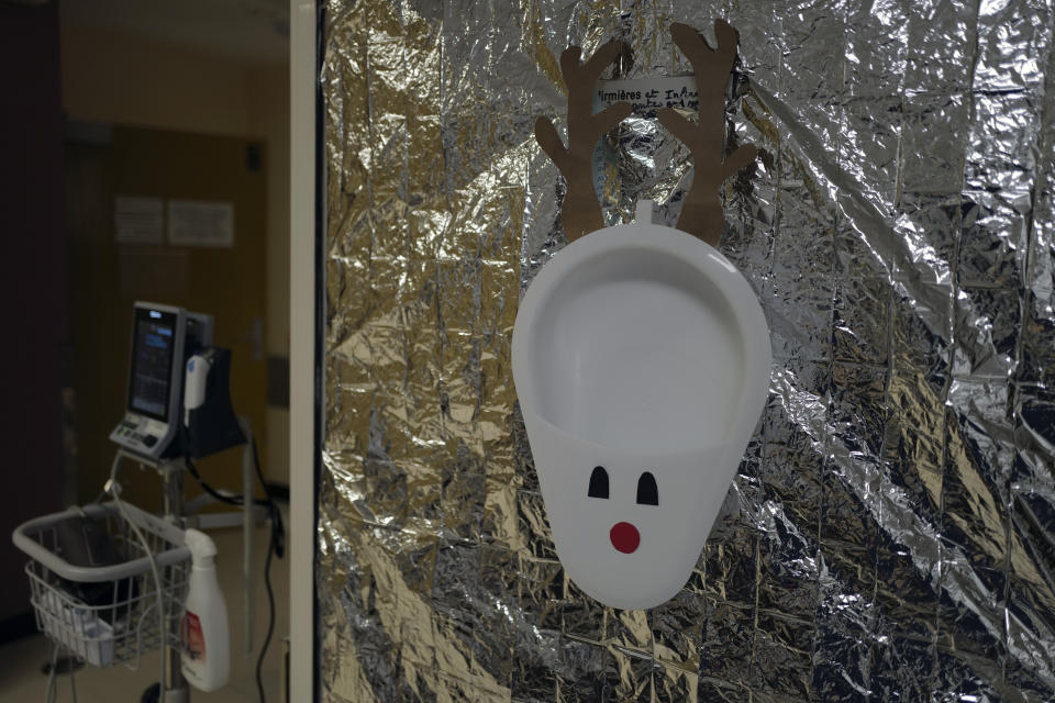 A urine basin is decorated as one of Santa's reindeer on the room door of the nurses at Bichat Hospital, AP-HP, in Paris Tuesday, Dec. 1, 2020. One of the biggest hospitals in Paris, Bichat Hospital, this month reopened all 22 of its operating rooms. It is once again performing surgeries that were stopped during virus surges that pushed France's death toll past 55,000. (AP Photo/Francois Mori)