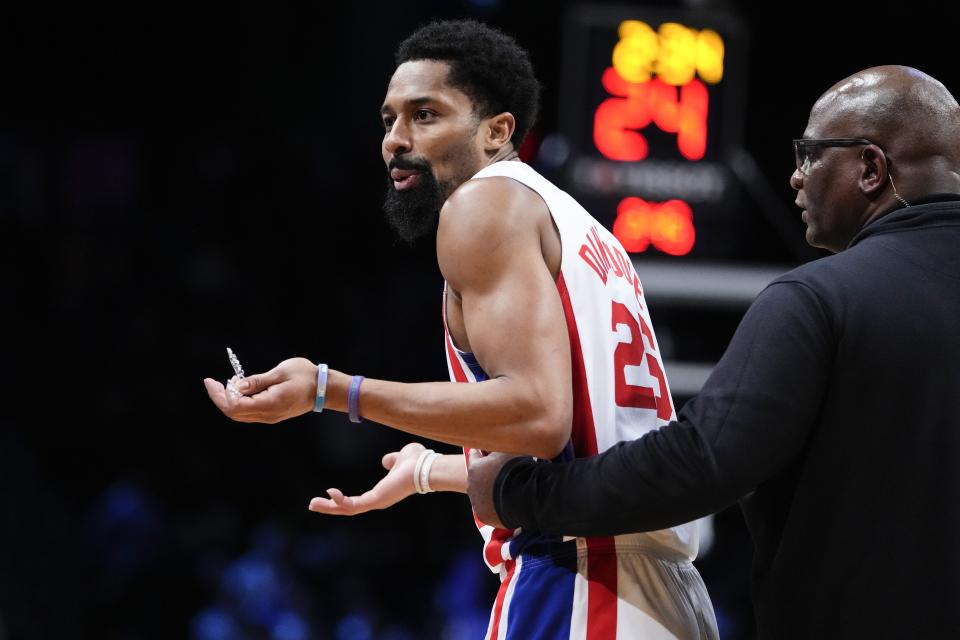 Brooklyn Nets' Spencer Dinwiddie (26) is restrained after being called for a technical foul during the first half of the team's NBA basketball game against the Sacramento Kings on Thursday, March 16, 2023, in New York. (AP Photo/Frank Franklin II)