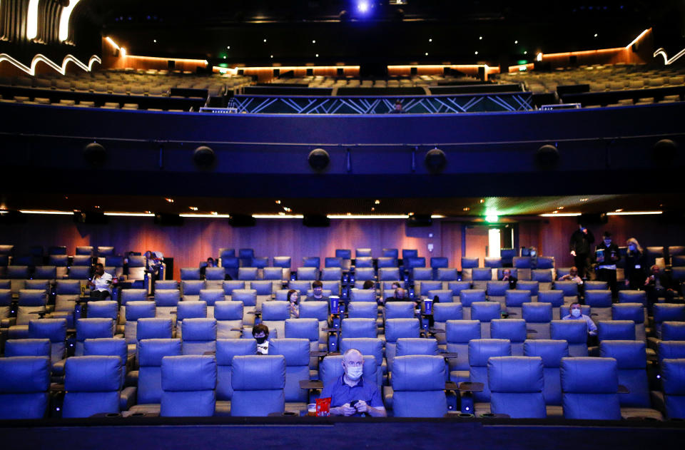 People take their seats inside the Odeon Luxe Leicester Square cinema, on the opening day of the film "Tenet", amid the coronavirus disease (COVID-19) outbreak, in London, Britain, August 26, 2020. REUTERS/Henry Nicholls