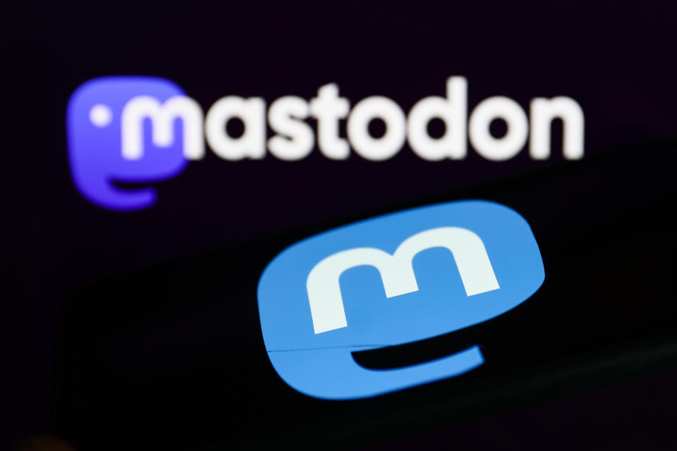 Mastodon logo displayed on a phone screen and Mastodon website logo displayed on a screen in the background are seen in this illustration photo taken in Krakow, Poland on November 5, 2022. (Photo by Jakub Porzycki/NurPhoto via Getty Images)
