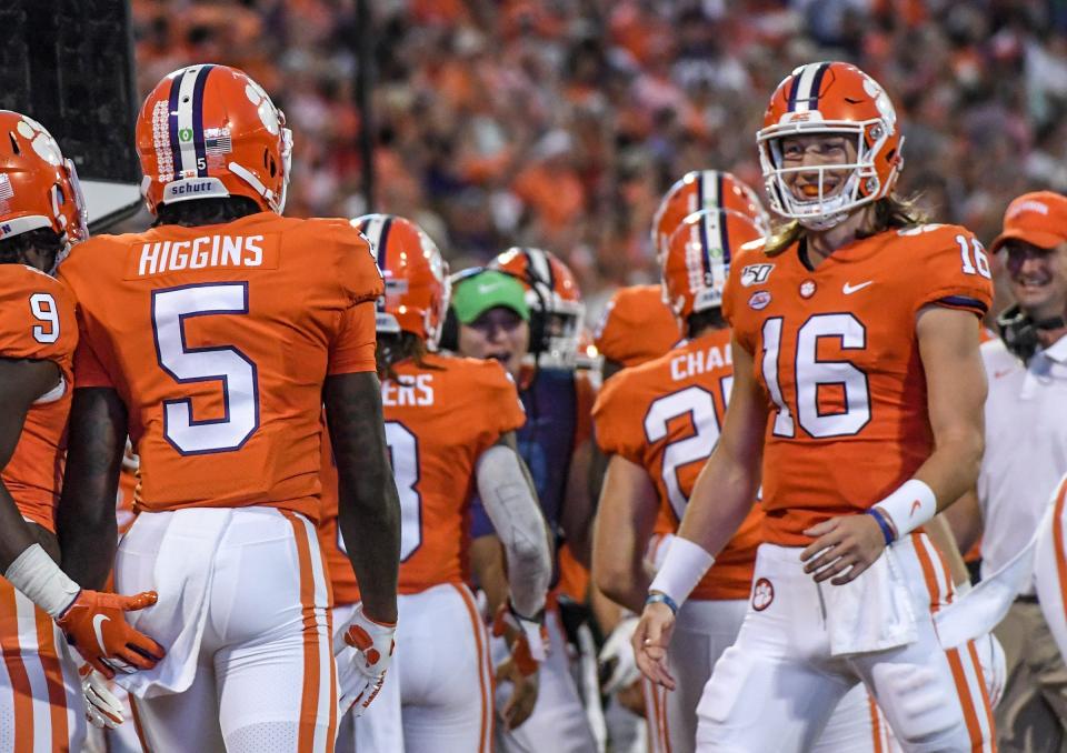 Clemson wide receiver Tee Higgins (5) is greeted by quarterback Trevor Lawrence (16) after the two connected for a 58-yard touchdown pass play during the first quarter at Memorial Stadium in Clemson, South Carolina Saturday, September 21, 2019.

Clemson Charlotte Football