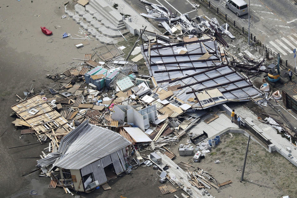 Beach houses are damaged as typhoon hits the beacfront area in Miura, south of Tokyo, Monday, Sept. 9, 2019. Typhoon Faxai is blowing across the Tokyo metropolitan area, disrupting travel, knocking out power and causing dozens of injuries. (Kyodo News via AP)