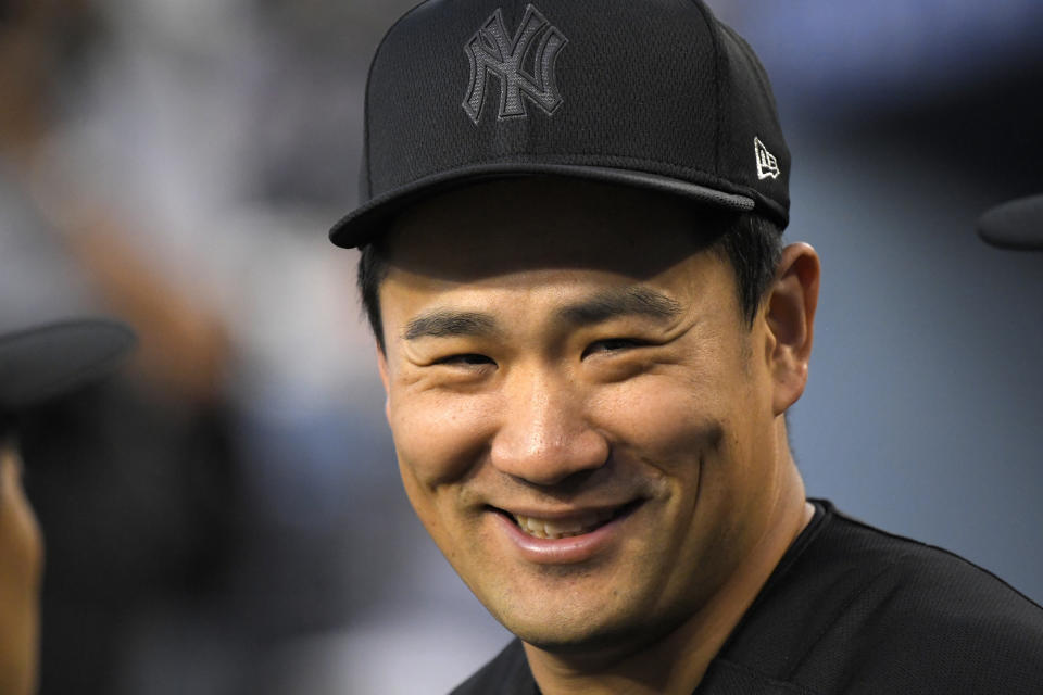 New York Yankees' Masahiro Tanaka, of Japan, smiles in the dugout during the first inning of a baseball game against the Los Angeles Dodgers, Friday, Aug. 23, 2019, in Los Angeles. (AP Photo/Mark J. Terrill)