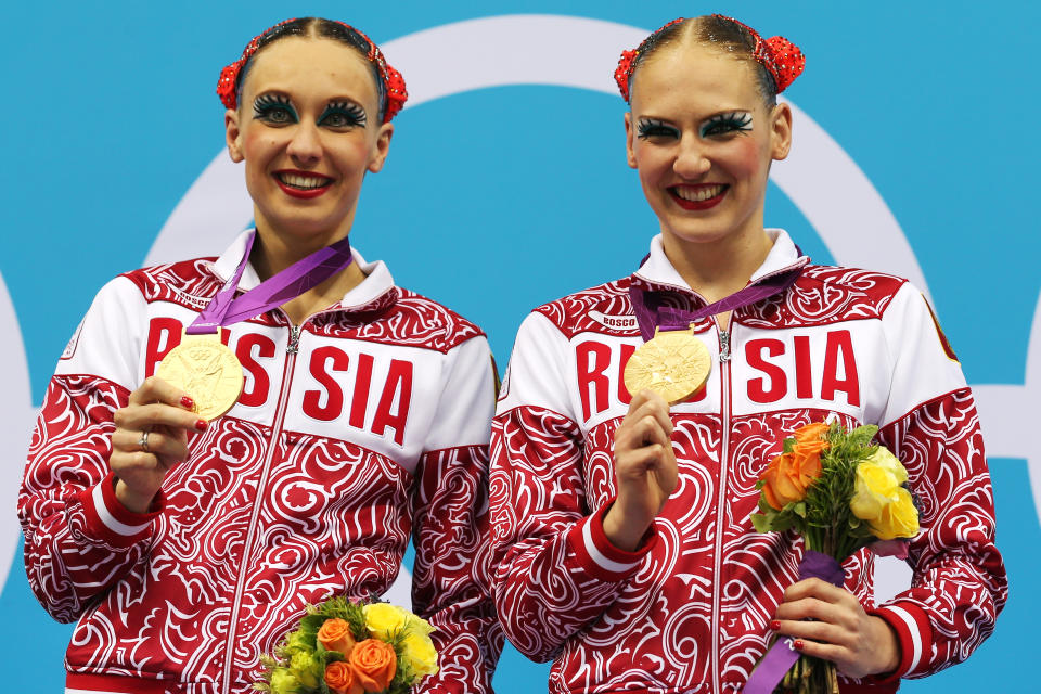 LONDON, ENGLAND - AUGUST 07: Gold medallists Natalia Ishenko and Svetlana Romashina of Russia pose on the podium following the medal ceremony for the Women's Duets Synchronised Swimming Free Routine Final on Day 11 of the London 2012 Olympic Games at the Aquatics Centre on August 7, 2012 in London, England. (Photo by Clive Rose/Getty Images)