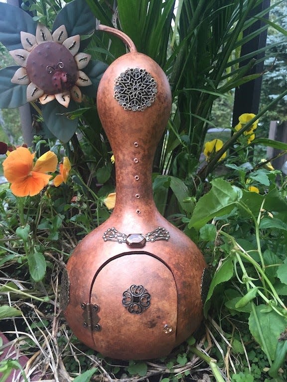 One of Robb's gourd art creations is shown.