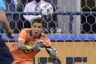 Minnesota United goalkeeper Dayne St. Clair dives to make a stop on a shot by Seattle Sounders defender Xavier Arreaga (not shown) during the first half of an MLS soccer match, Friday, April 16, 2021, in Seattle. (AP Photo/Ted S. Warren)