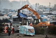 Members of the French demolition crew tear down the "Jungle" migrant camp in Calais, northern France