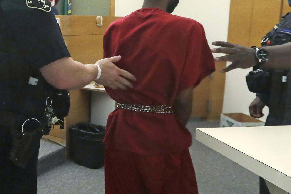 Dawit Kelete wears handcuffs chained to his waist as he walks out of a court appearance Monday, July 6, 2020, in Seattle. Kelete is accused of driving a car on to a closed Seattle freeway and hitting two protesters, killing one, over the weekend. Seattle has been the site of prolonged unrest over the death of George Floyd, a Black man who was in police custody in Minneapolis and had shut down the interstate for 19 days in a row. (AP Photo/Elaine Thompson)