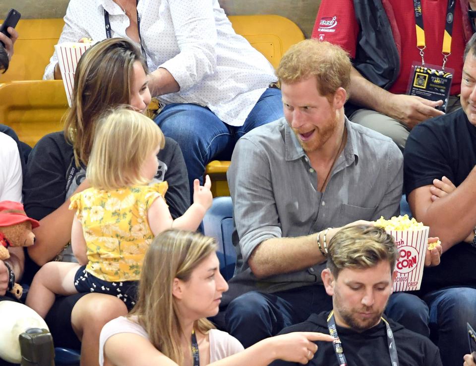 The Prince appeared to pretend to snatch the little girl's popcorn away from her.