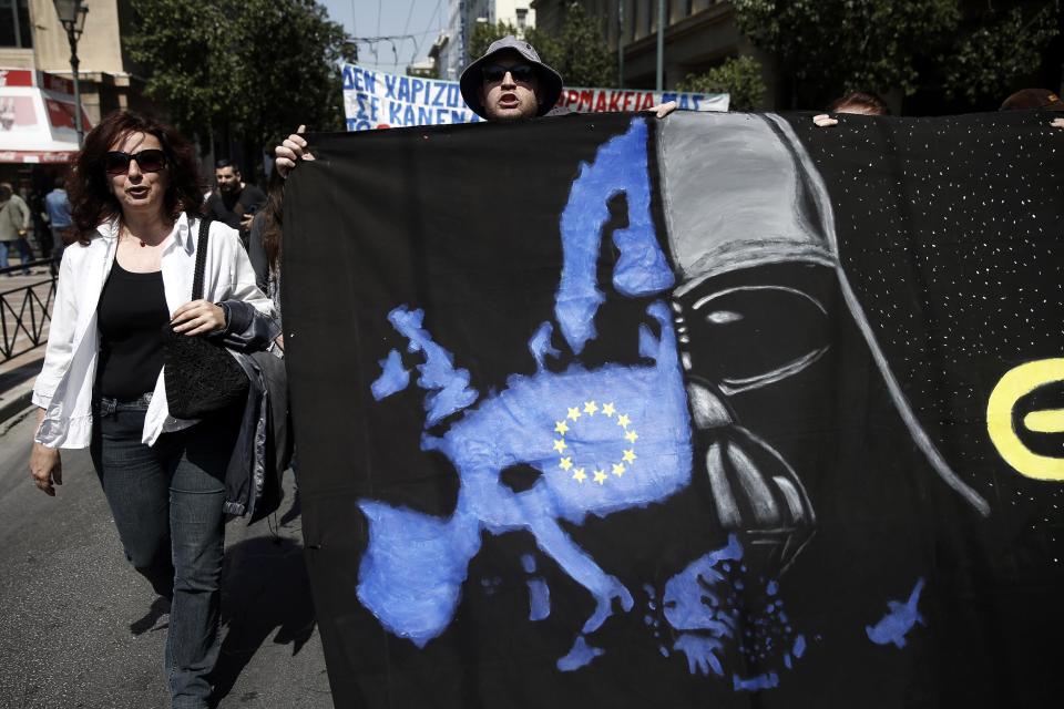 Protesters carry an anti-EU banner during a 24-hour nationwide general strike, in Athens, Wednesday, April 9, 2014. Unions say they are seeking an end to the painful savings policies that successive governments imposed to secure international bailout loans after Greece nearly went bankrupt in 2010. The repeated income cuts and tax hikes deepened a six-year recession, while unemployment has reached a record 28 percent. (AP Photo/ Petros Giannakouris)