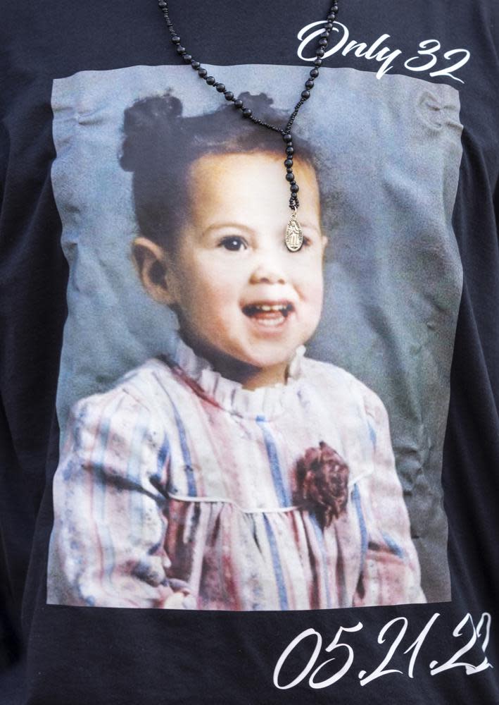 Enrique Owens, a cousin of Roberta Drury, wears a t-shirt with a photograph of her as a little girl before her funeral service, Saturday, May 21, 2022, in Syracuse, N.Y. (AP Photo/Lauren Petracca)