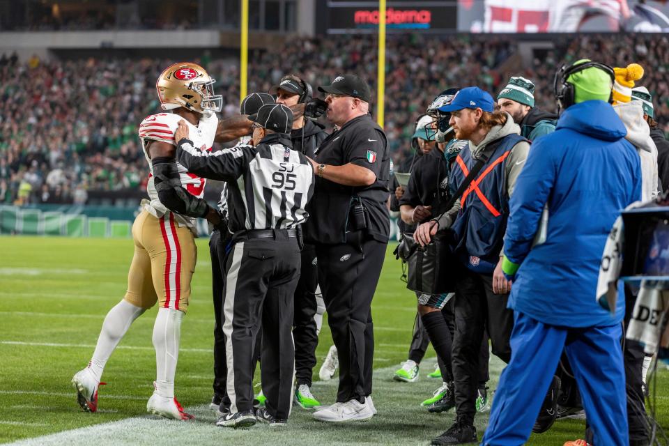 San Francisco 49ers linebacker Dre Greenlaw (57) swings at Philadelphia Eagles head of security Dom DiSandro before both being ejected in an NFL football game, Sunday, Dec. 3, 2023, in Philadelphia, PA. 49ers defeat the Eagles 42-19.