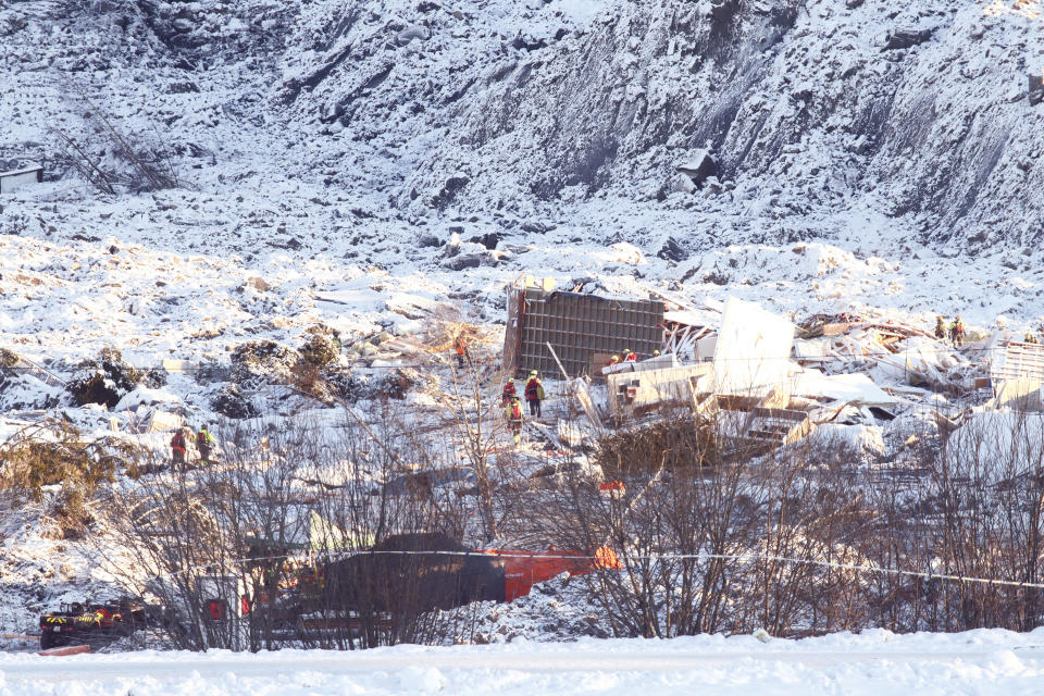 Rescue workers continue their efforts on the site of a major landslide in Ask, Norway, Monday, Jan. 4, 2021. Norwegian officials are insisting that there's “still hope” of finding survivors in air pockets five days after a landslide killed at least seven people as it carried away homes in a village near the capital. Three people are still missing. (Terje Pedersen/NTB via AP)