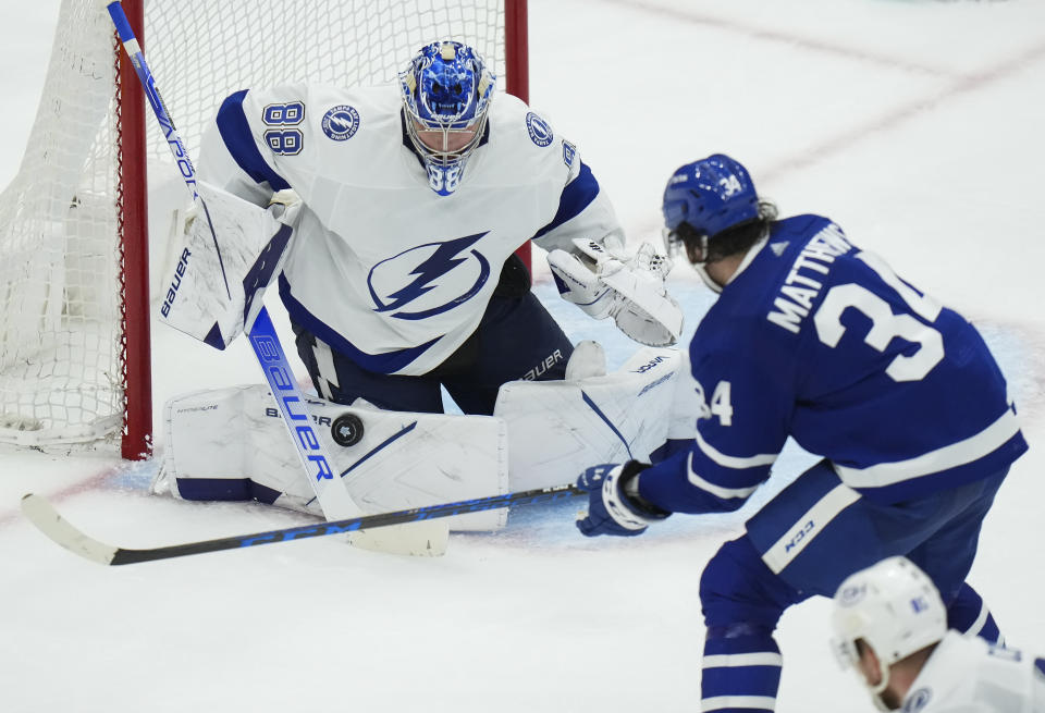 Toronto Maple Leafs forward Auston Matthews (34) is stopped by Tampa Bay Lightning goaltender Andrei Vasilevskiy (88) during the third period of Game 7 in an NHL hockey first-round playoff series in Toronto, Saturday, May 14, 2022. (Nathan Denette/The Canadian Press via AP)