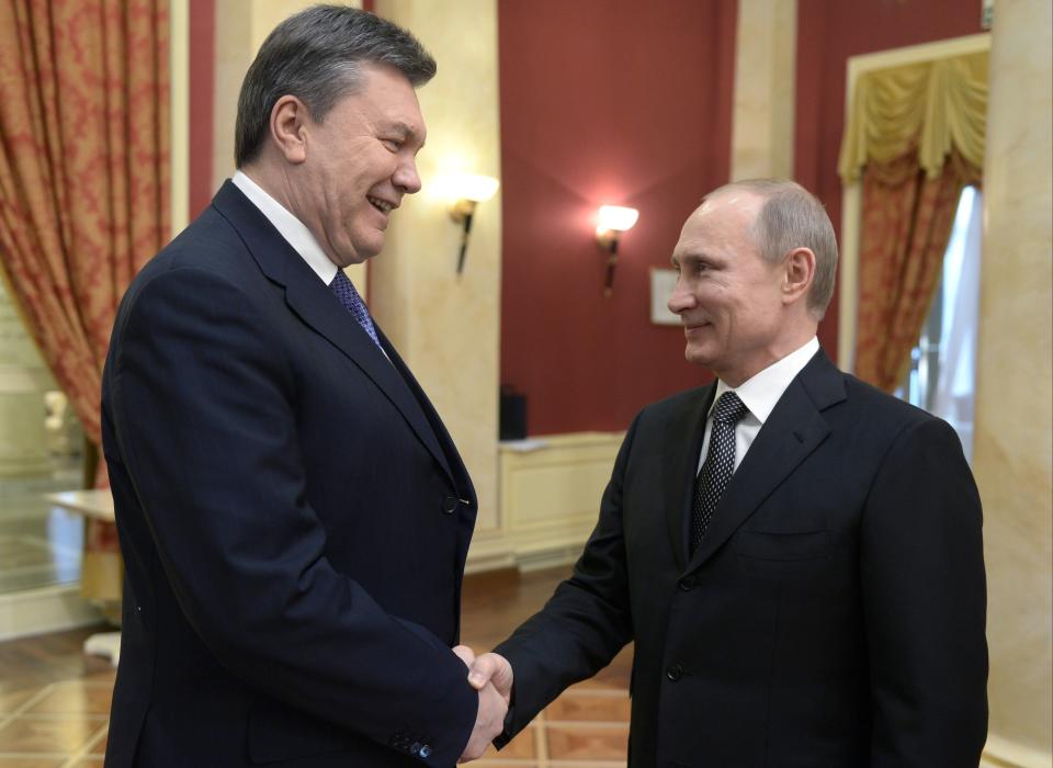 FILE - Russian President Vladimir Putin, right, shakes hands with Ukrainian President Viktor Yanukovych at an Olympic reception in Sochi, Russia on Friday, Feb. 7, 2014. Despite the costly effort by the Kremlin to make the Sochi Games a symbol of Russia's power and prestige, global attention soon focused on clashes between police and protesters who rallied against Ukraine's Moscow-backed president in the streets of Kyiv. (Alexei Nikolsky, Sputnik, Kremlin Pool Photo via AP, File)