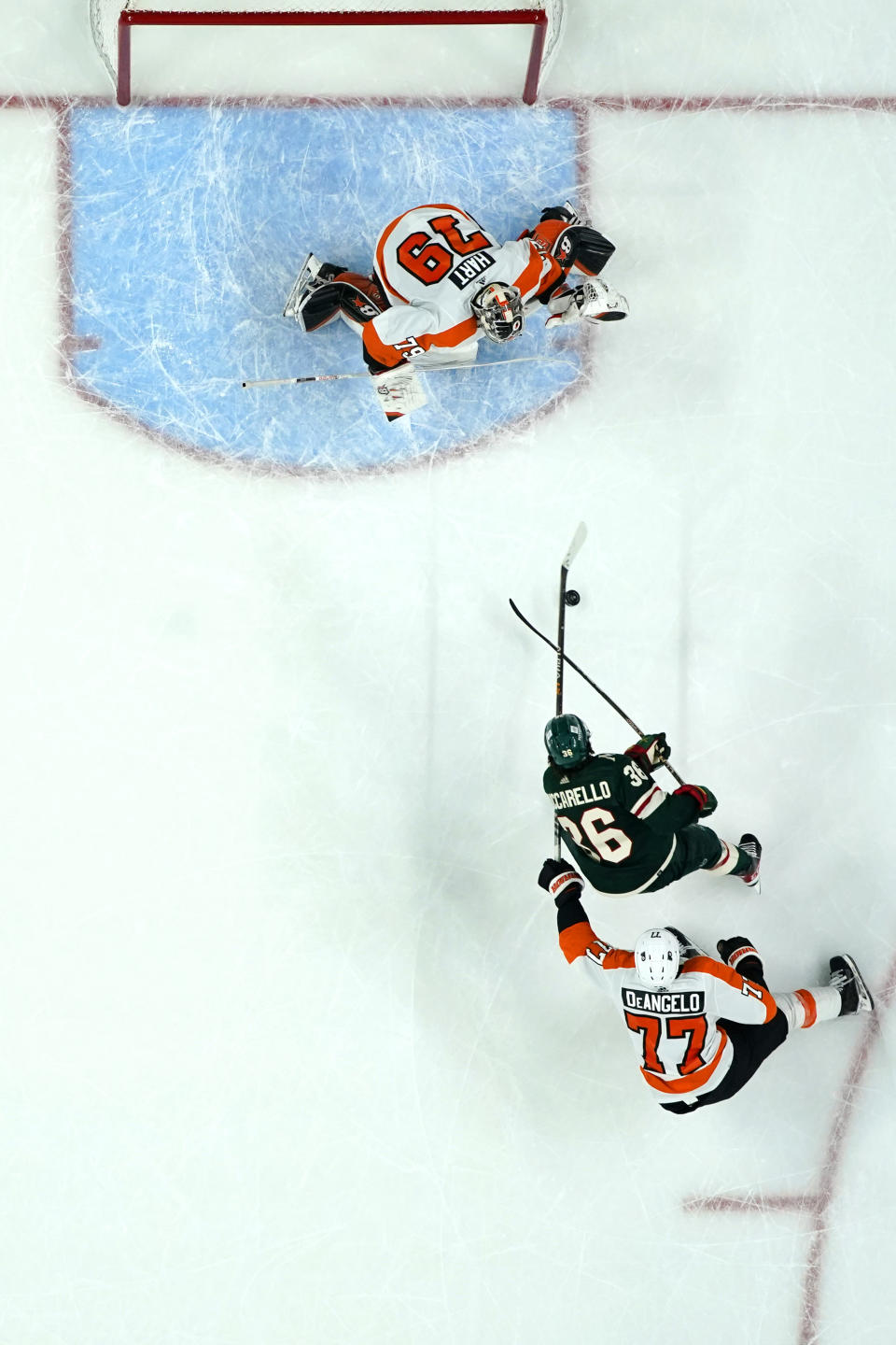 Minnesota Wild right wing Mats Zuccarello (36) shoots and scores the winning goal past Philadelphia Flyers goaltender Carter Hart (79) and defenseman Tony DeAngelo (77) during overtime of an NHL hockey game Thursday, Jan. 26, 2023, in St. Paul, Minn. (AP Photo/Abbie Parr)