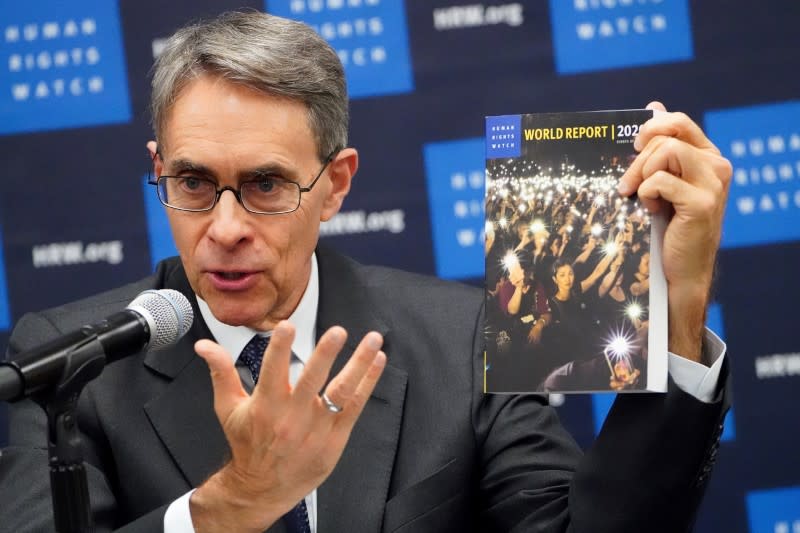 Kenneth Roth, the Executive Director of Human Rights Watch holds up their World Report 2020 at the United Nations in the Manhattan borough of New York City