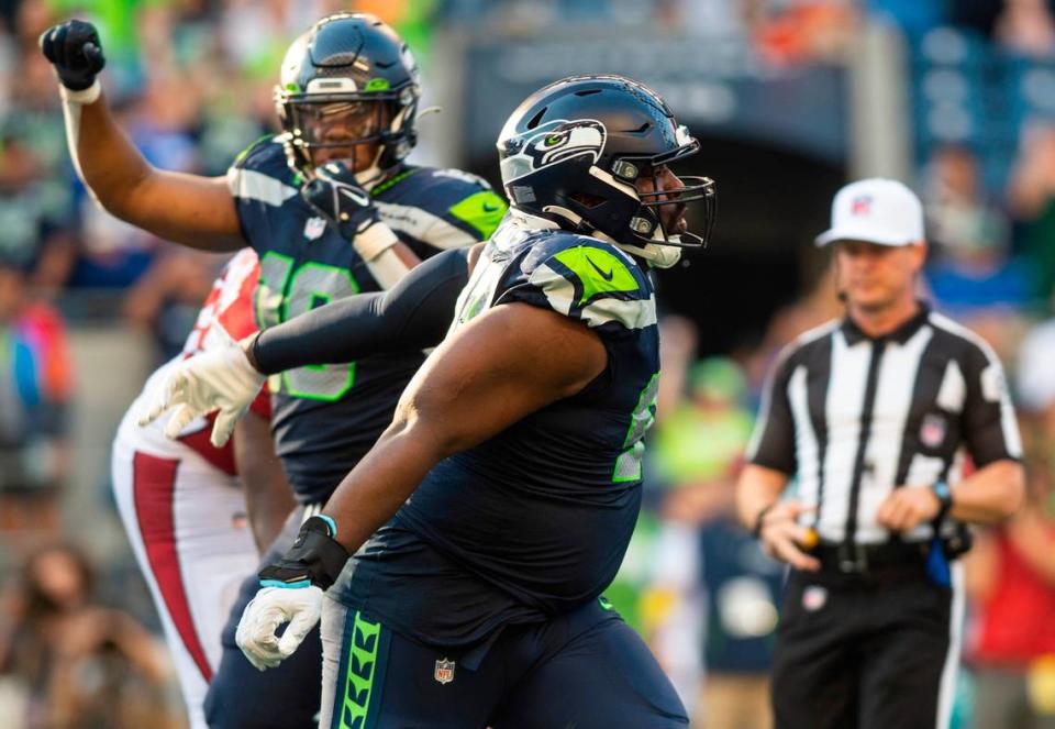 Seattle Seahawks defensive end Shelby Harris (93) celebrates after tackling Arizona Cardinals quarterback Kyler Murray (1) in the fourth quarter of an NFL game on Sunday, Oct. 16, 2022, at Lumen Field in Seattle.