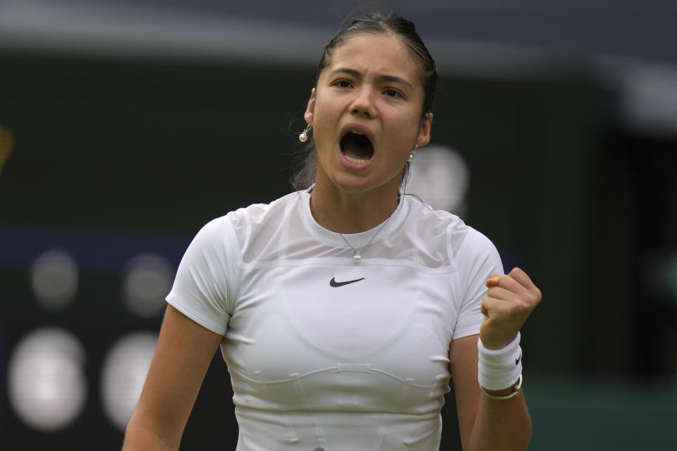 Britain's Emma Raducanu celebrates winning a point against France's Caroline Garcia during their singles tennis match against on day three of the Wimbledon tennis championships in London, Wednesday, June 29, 2022. (AP Photo/Alastair Grant)