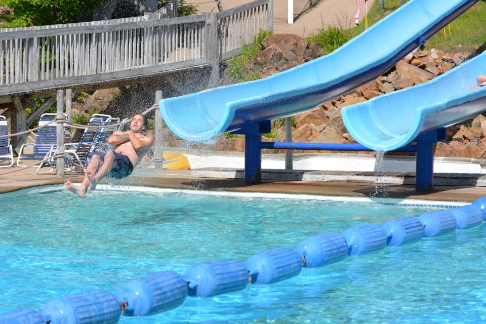 A visitor plummets down a water slide at Enchanted Forest Water Safari in Old Forge. Neighboring recreation park Calypso's Cove will not open this summer due to a shortage of staff.