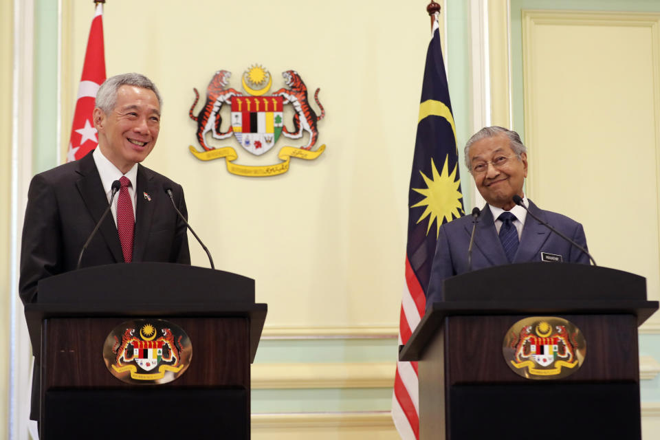 Malaysian Prime Minister Mahathir Mohamad, right, gesture as he speaks next to Singaporean Prime Minister Lee Hsien Loong during a press conference in Putrajaya, Malaysia, Tuesday, April 9, 2019. Lee is in Malaysia for a two-day working visit. (AP Photo/Vincent Thian)