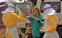 In this photo provided by MSF, Medecins Sans Frontieres (Doctors without Borders), taken on Friday, March 28, 2014, healthcare workers from the organisation, react, as they prepare isolation and treatment areas for their Ebola, hemorrhagic fever operations, in Gueckedou, Guinea. (AP Photo/Kjell Gunnar Beraas, MSF)