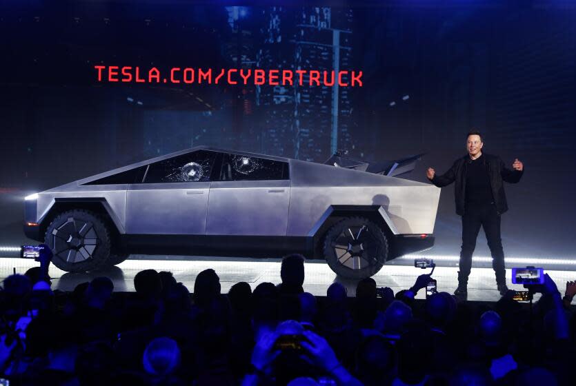 Tesla CEO Elon Musk introduces the Cybertruck at Tesla's design studio Thursday, Nov. 21, 2019, in Hawthorne, Calif. Musk is taking on the workhorse heavy pickup truck market with his latest electric vehicle. (AP Photo/Ringo H.W. Chiu)